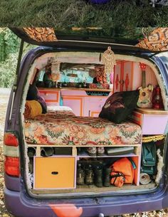 the back end of a van with an open trunk and bed in it's trunk