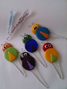 some kind of cake toppers with eyes on them and one has a toothbrush in it
