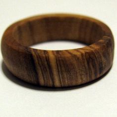 a wooden ring sitting on top of a white table