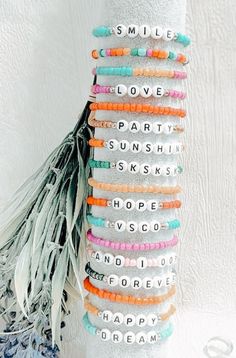 a stack of bracelets with words written on them