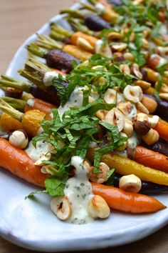 a white plate topped with carrots and other vegetables