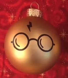 a harry potter ornament hanging on a red background with stars and snowflakes