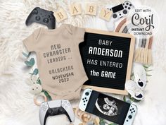 an image of baby clothes and video game controllers on the floor with text that reads, baby anderson has entered the game