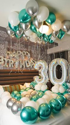 balloons and streamers in the shape of numbers are on display at a 30th birthday party