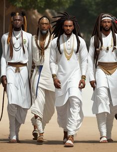 three men in white outfits walking down the street with dreadlocks on their heads