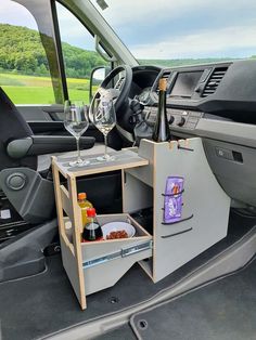 an open trunk in the back of a vehicle filled with wine bottles and other items