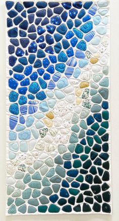 a piece of art made out of blue and white rocks