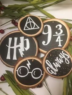 four decorated cookies with harry potter symbols on them