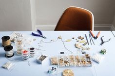 the table is covered with crafting supplies such as buttons, beads, and scissors