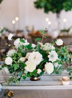 Silver bowls filled with naturally shaped, loose arrangements of silver dollar eucalyptus, ivory roses, nagi foliage, white veronica, olive leaves, ivory spray roses and white ranunculus. Centrepieces, Neutral Wedding, Wedding Chair Decorations, Ceremony Decorations, Greenery Wedding