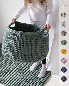 a woman standing next to a knitted basket
