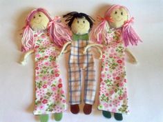 three dolls are hanging on the wall