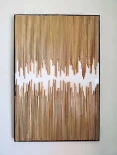 a painting made out of bamboo sticks on the wall