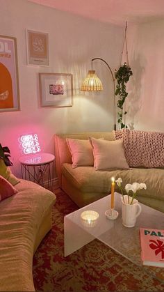 a living room filled with furniture and a pink light on the wall above it's coffee table