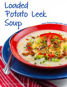 a bowl of loaded potato leek soup on a blue plate with a red and white towel