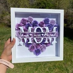 "This shadow box is the perfect gift for a mom, grandma or special person in your life. The shadowbox is 9\"x9\" and can sit on a shelf or tabletop but also has attached hardware for wall handing. The shadowbox it's filled with dozens of hands rolled flowers to create a beautiful floral heart or full floral background (specify this under the personalization box).  This box is finished with custom design vinyl lettering on glass which says \"MOM\" \"NANA\" \"GRANNY\" \"MUM\" \"GRANDMA\" (can be c