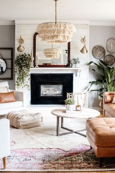 a living room filled with furniture and a fire place in front of a mirror on the wall