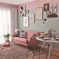 a living room filled with furniture and pictures hanging on the wall above a dining table