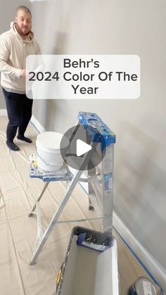 a man standing next to a white bucket on top of a hard wood floor with the words behr's color of the year