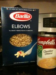 an empty can of campbell cheese next to a box of elbow macaroni and cheese