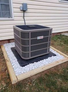 an air conditioner sitting in front of a house