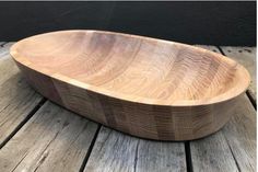 a wooden bowl sitting on top of a wooden table