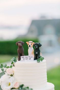 three dogs on top of a wedding cake