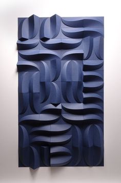 an abstract piece of art made out of blue paper