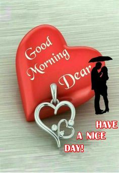 a couple holding an umbrella next to a heart shaped box with the words good morning dear on it
