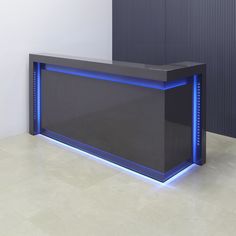 a large black counter with blue lights on the top and bottom shelf in front of it