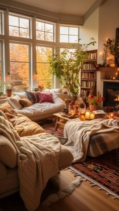 a living room filled with furniture and a fire place in front of a large window