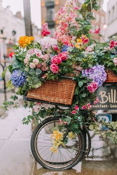 a bicycle with flowers in the basket is parked