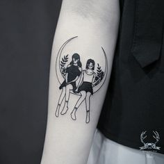 two women sitting on top of each other in the middle of a circle tattoo design