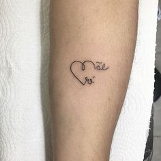 a person with a tattoo on their arm that says love and is written in the shape of a heart