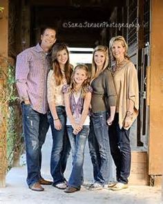 a family posing for a photo in front of an open door