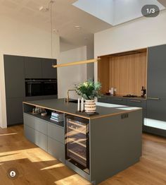 a kitchen with an oven, sink and counter top in the middle of it's wood flooring