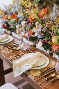 a long table is set with plates and place settings for an elegant dinner party or special event