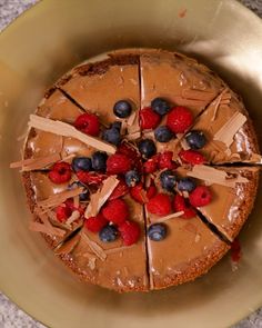 a cake with chocolate frosting and berries on top