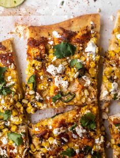several slices of flatbread with corn, feta cheese and cilantro on top