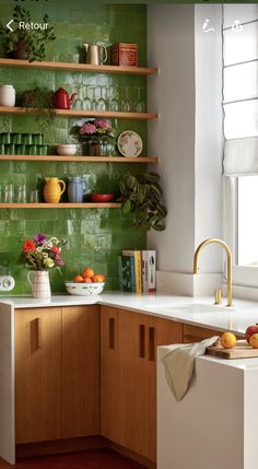 a kitchen with green wallpaper and wooden cabinets