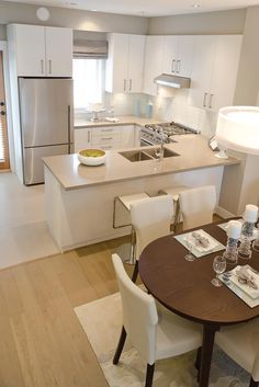 a kitchen and dining room with white furniture