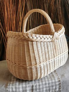 a wicker basket sitting on top of a cushion