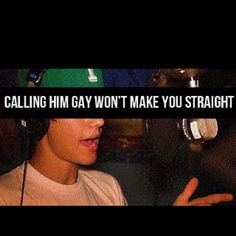 a young man wearing headphones talking into a microphone with the words calling him gay won't make you straight