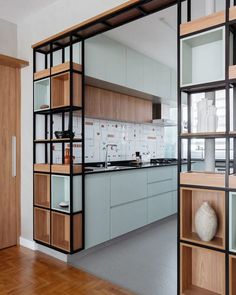 an open kitchen with wooden cabinets and shelves