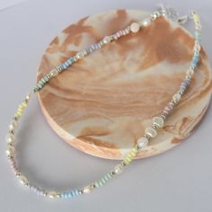 close up photo of a pastel beaded Pearl necklace against a white backdrop Design, Outfits, Beaded Jewellery, Pastel, Bead Jewellery