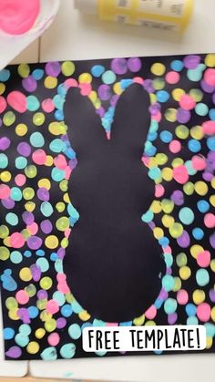 the silhouette of a bunny is painted on a black background with colorful circles and confetti