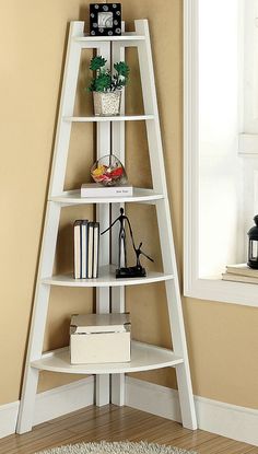 a white leaning shelf with books on it