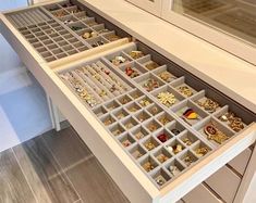 the drawers are filled with jewelry and earrings