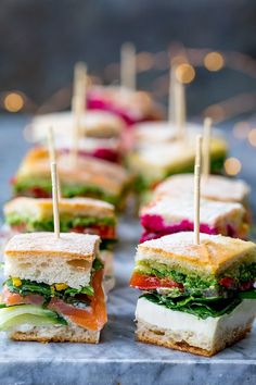 sandwiches with toothpicks in them sitting on a table