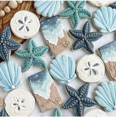 decorated cookies with shells and starfishs are displayed on a table next to beads